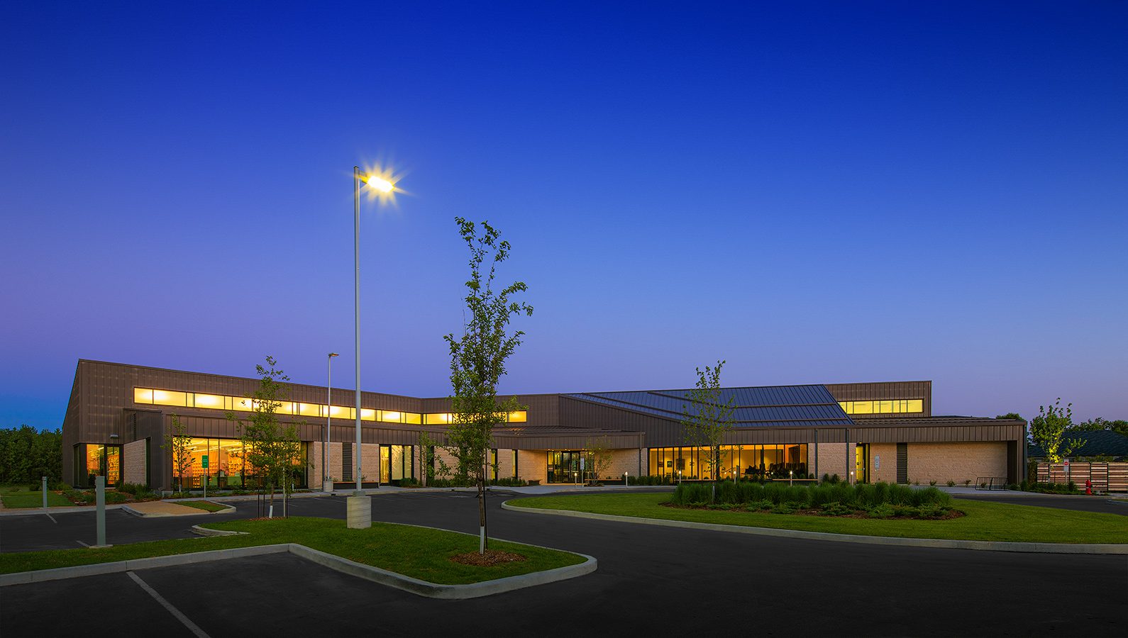 The exterior of Gaynor Family Regional Library at night.