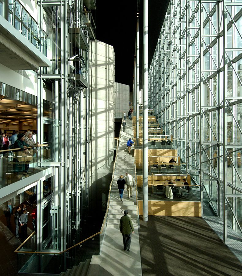 Millennium Library interior with people moving along the grand open stair.
